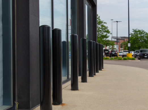 Row of black bollards installed outside a modern building in Toronto