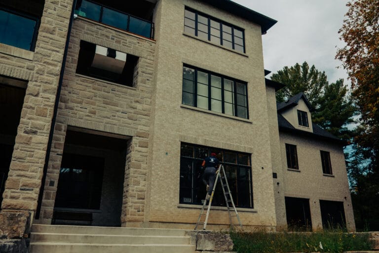 Stone house with a ladder set up at a window
