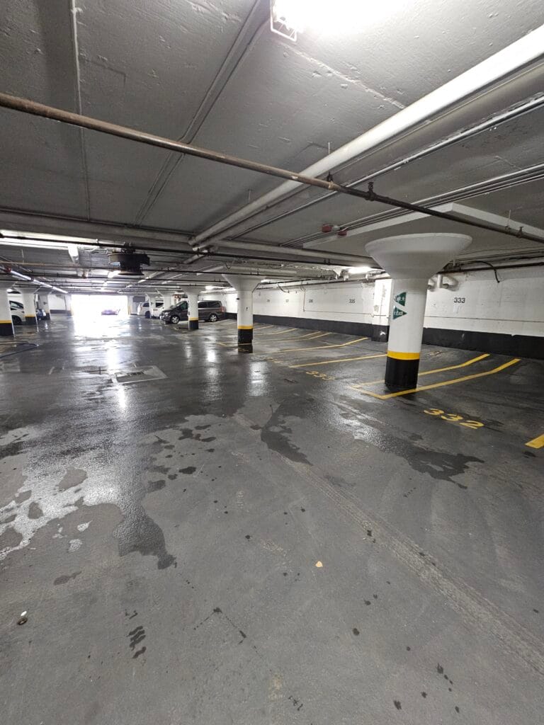 Wet concrete floor of an underground parking garage