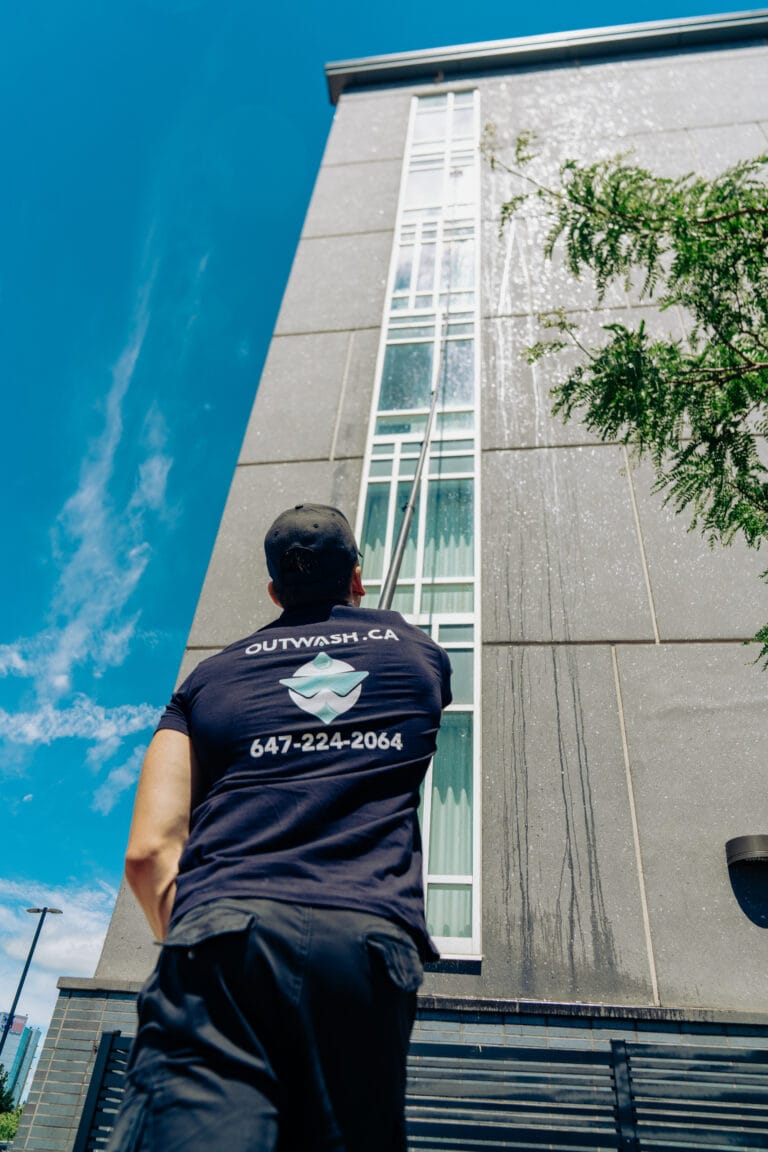 Outwash technician looking up at a tall building