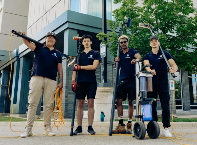 Four Outwash crew members with water-fed poles and a water filter cart